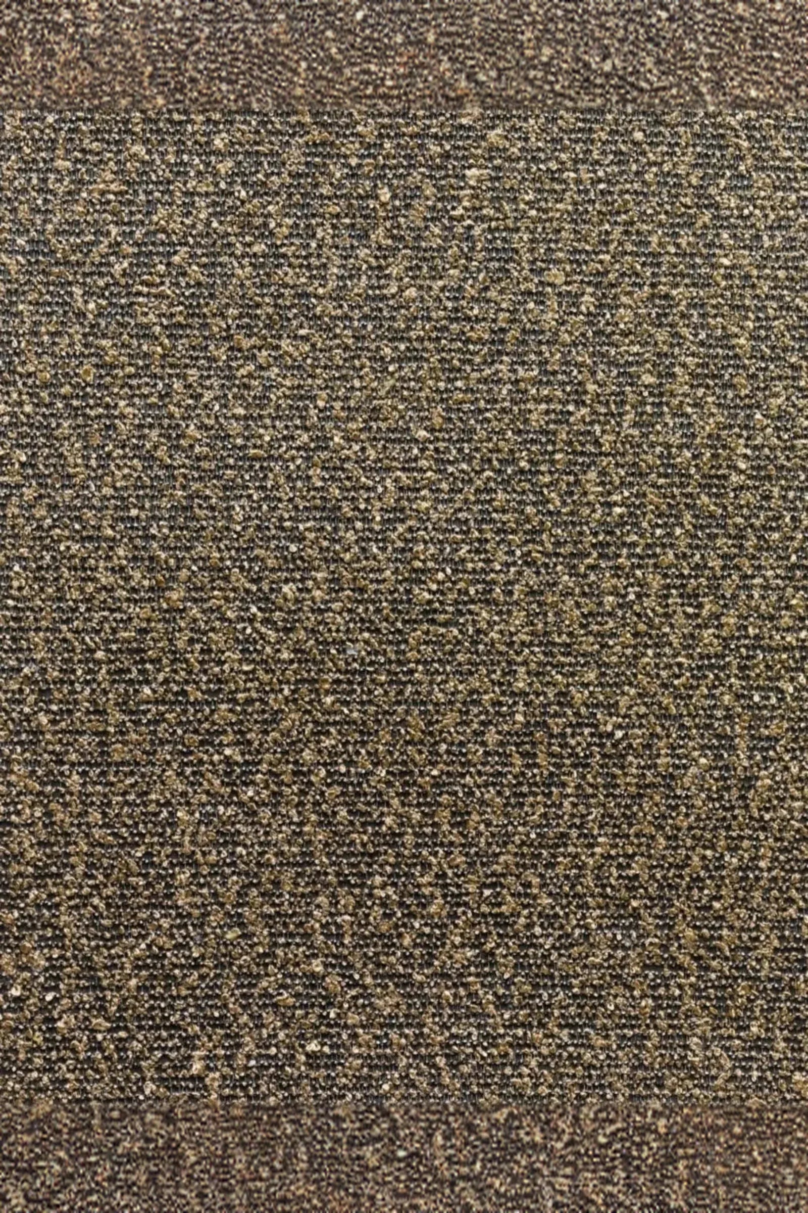 Close-up of textured brown and beige woven carpet fabric for luxury residential interiors