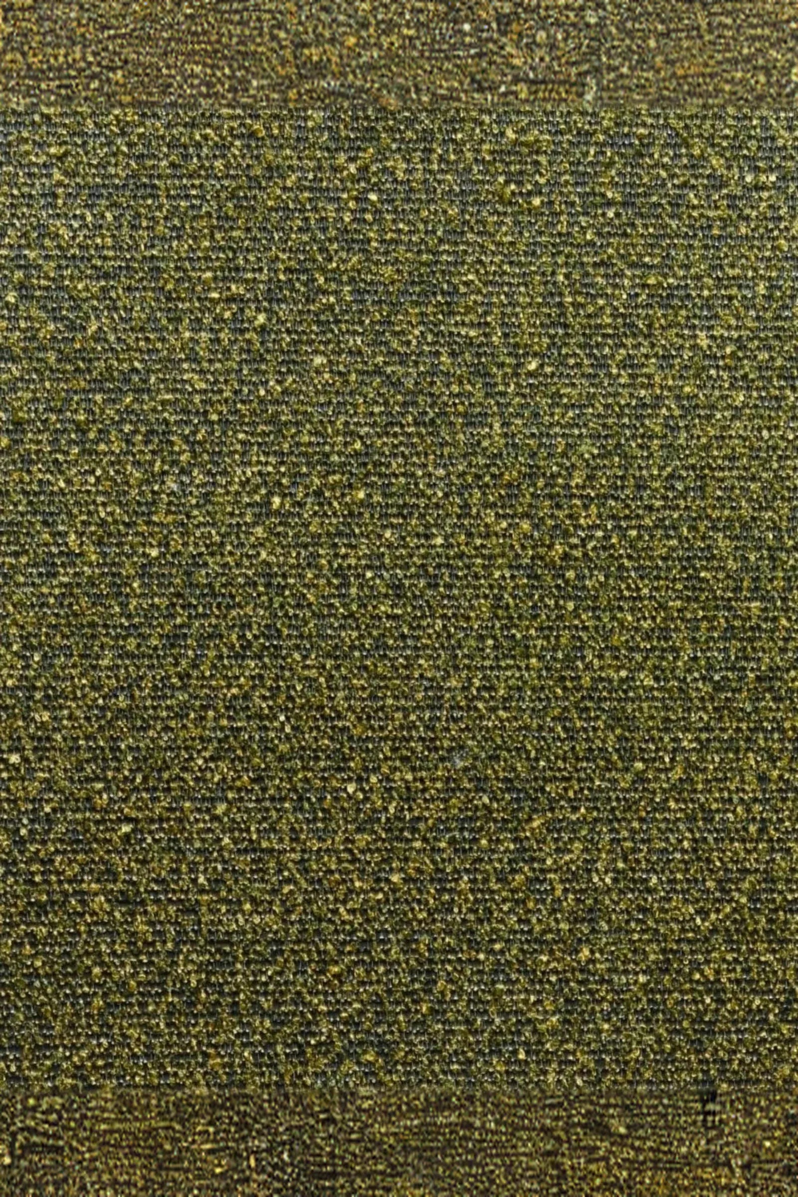 Close-up of luxury textured fabric with green and yellow woven pattern