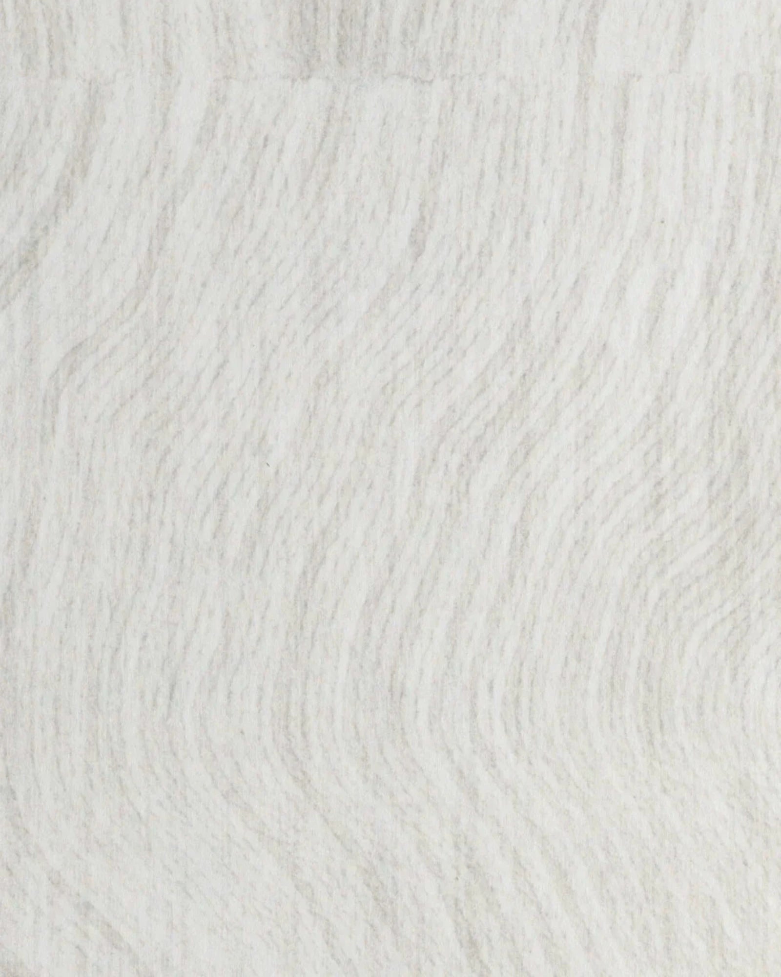 Textured white duvet fabric with subtle wavy pattern, close-up textile detail