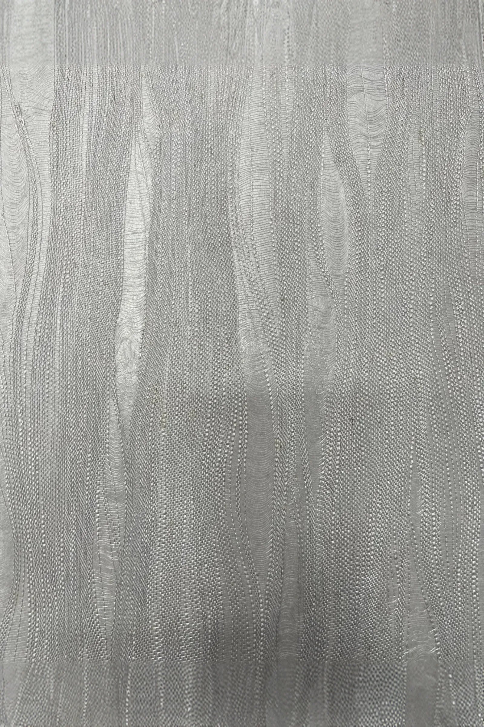 Textured silver metallic surface with wavy abstract pattern, luxury interior detail