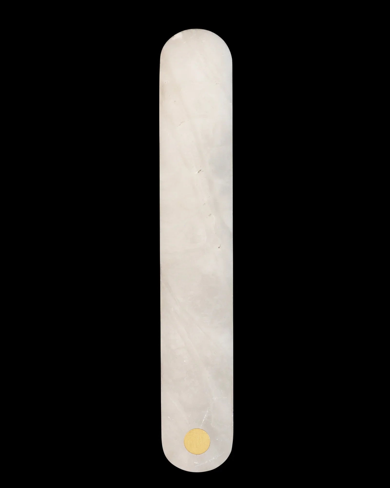 Minimalist rectangular white marble wall handle with rounded edges and gold accent on black background