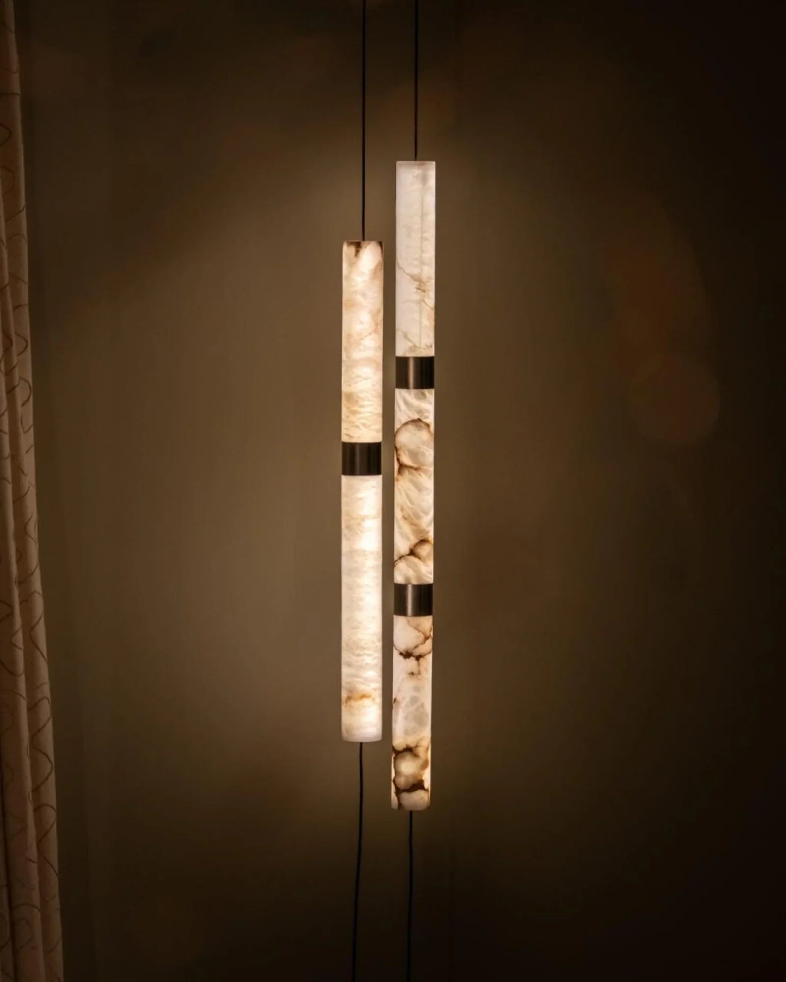 Elegant alabaster pendant lights with warm glow in a modern luxury interior setting