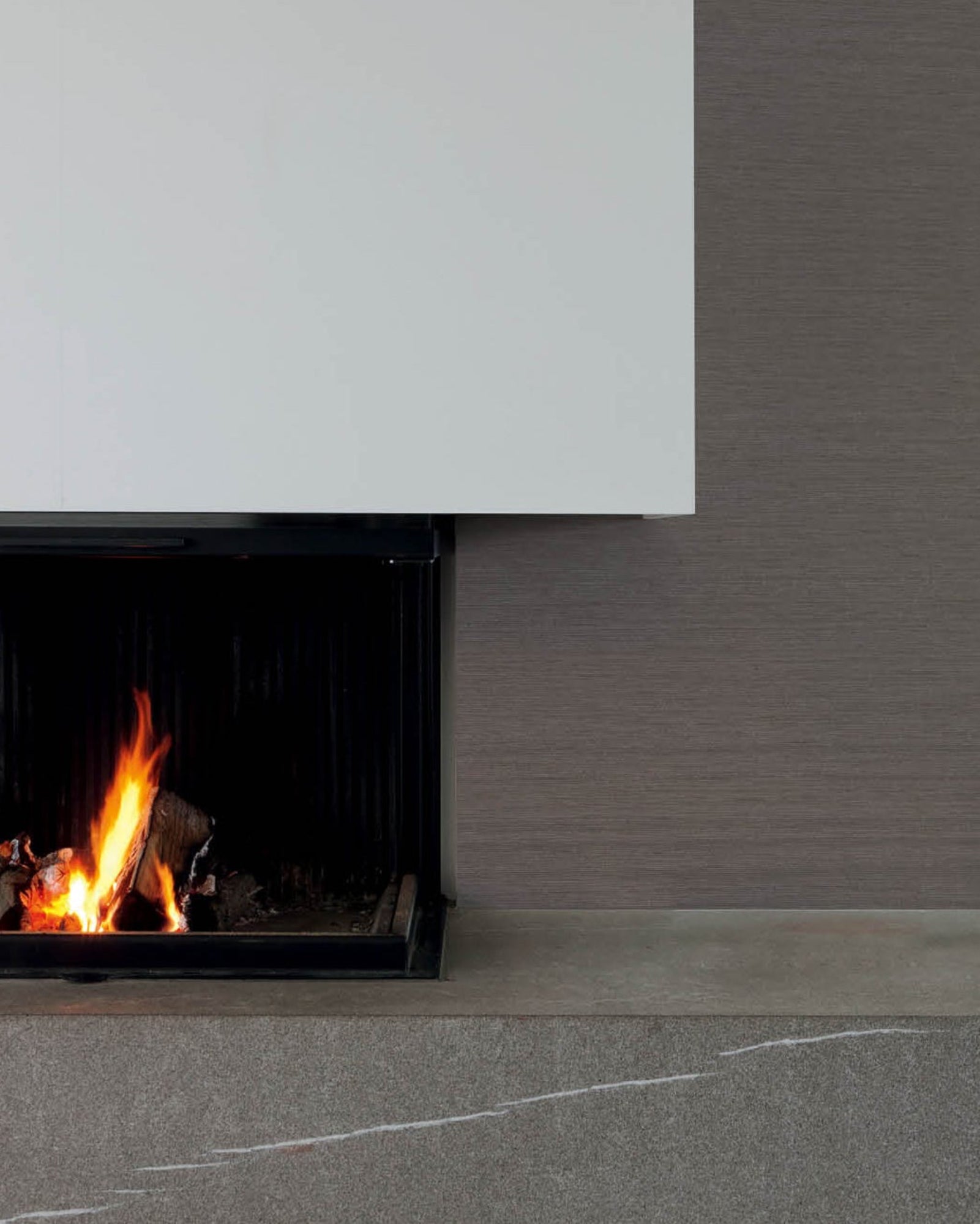Modern luxury fireplace with clean lines and natural stone hearth in stylish interior
