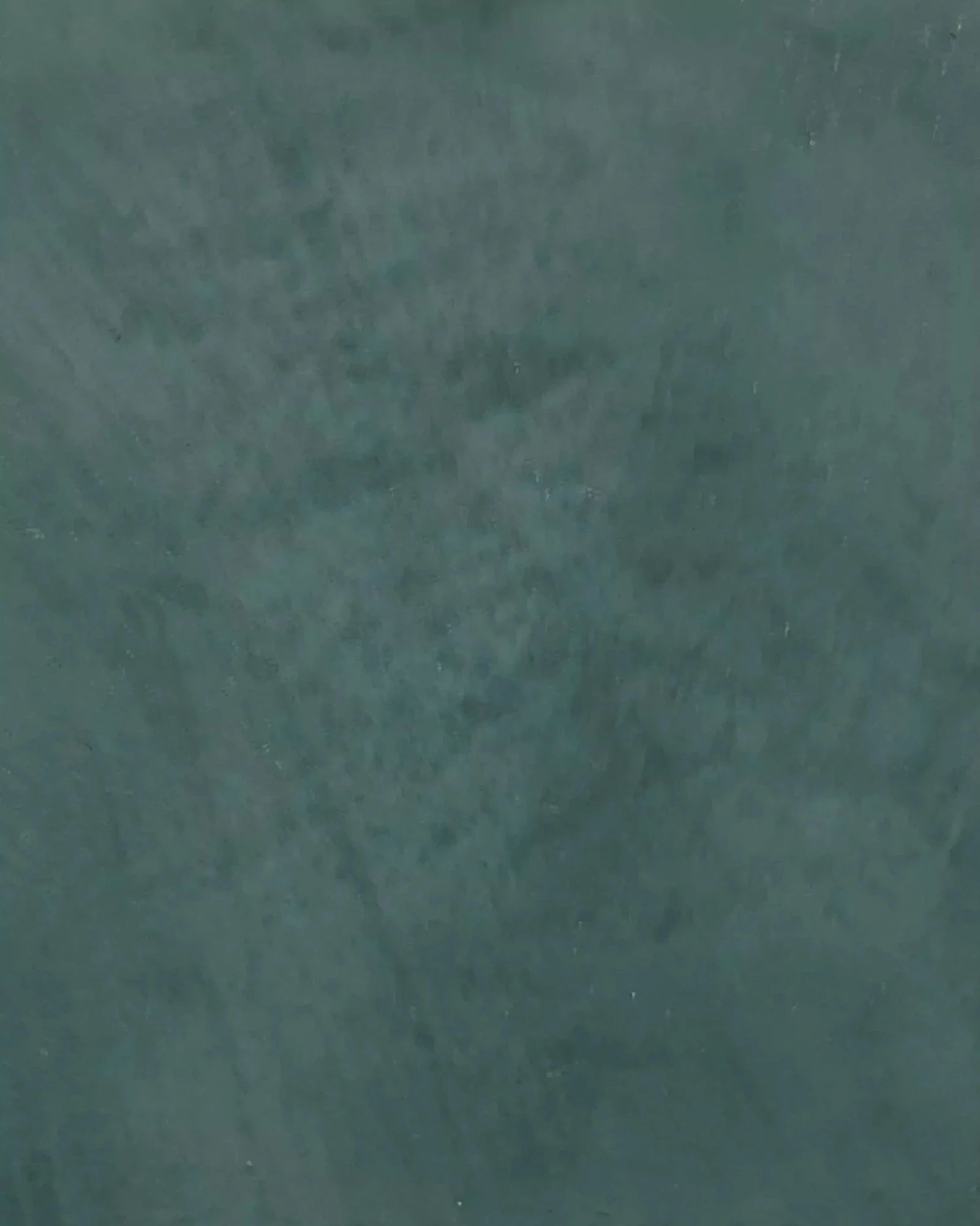 Close-up of textured dark green marble surface for luxury residential interiors