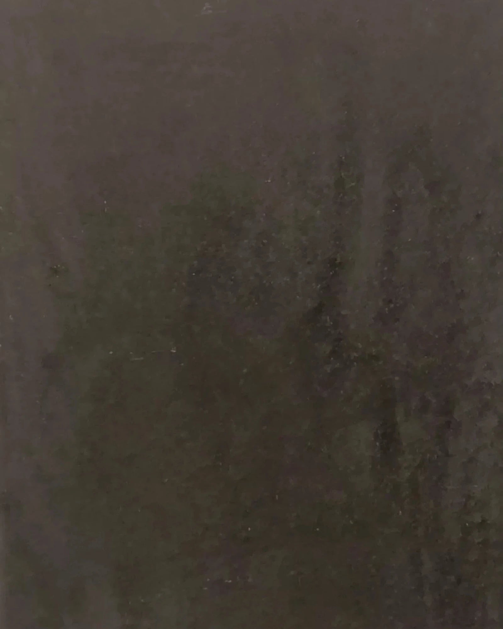 Dark stone surface with subtle texture, suitable for luxury interior design.