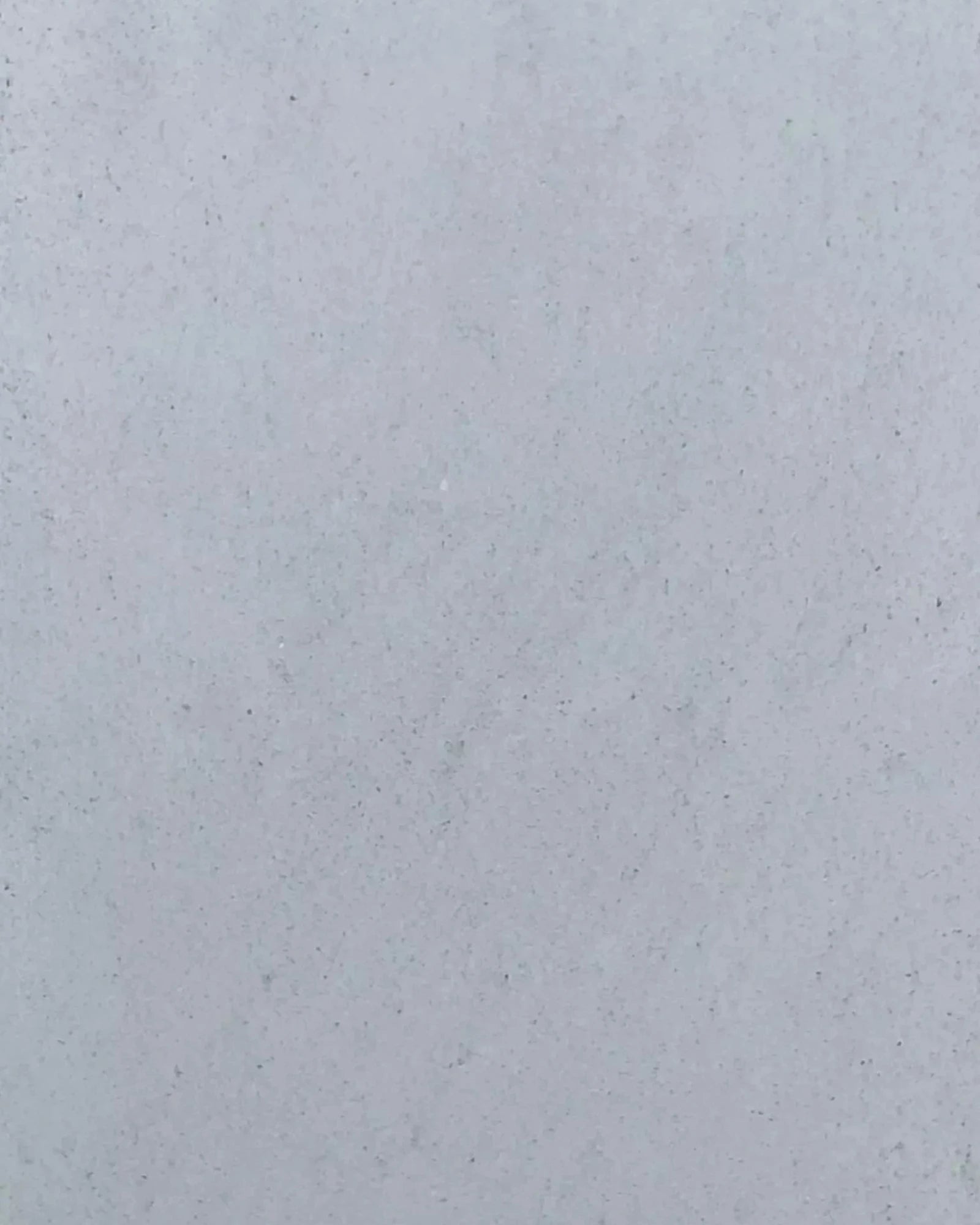 Light gray textured stone surface, suitable for luxury interior design accents.