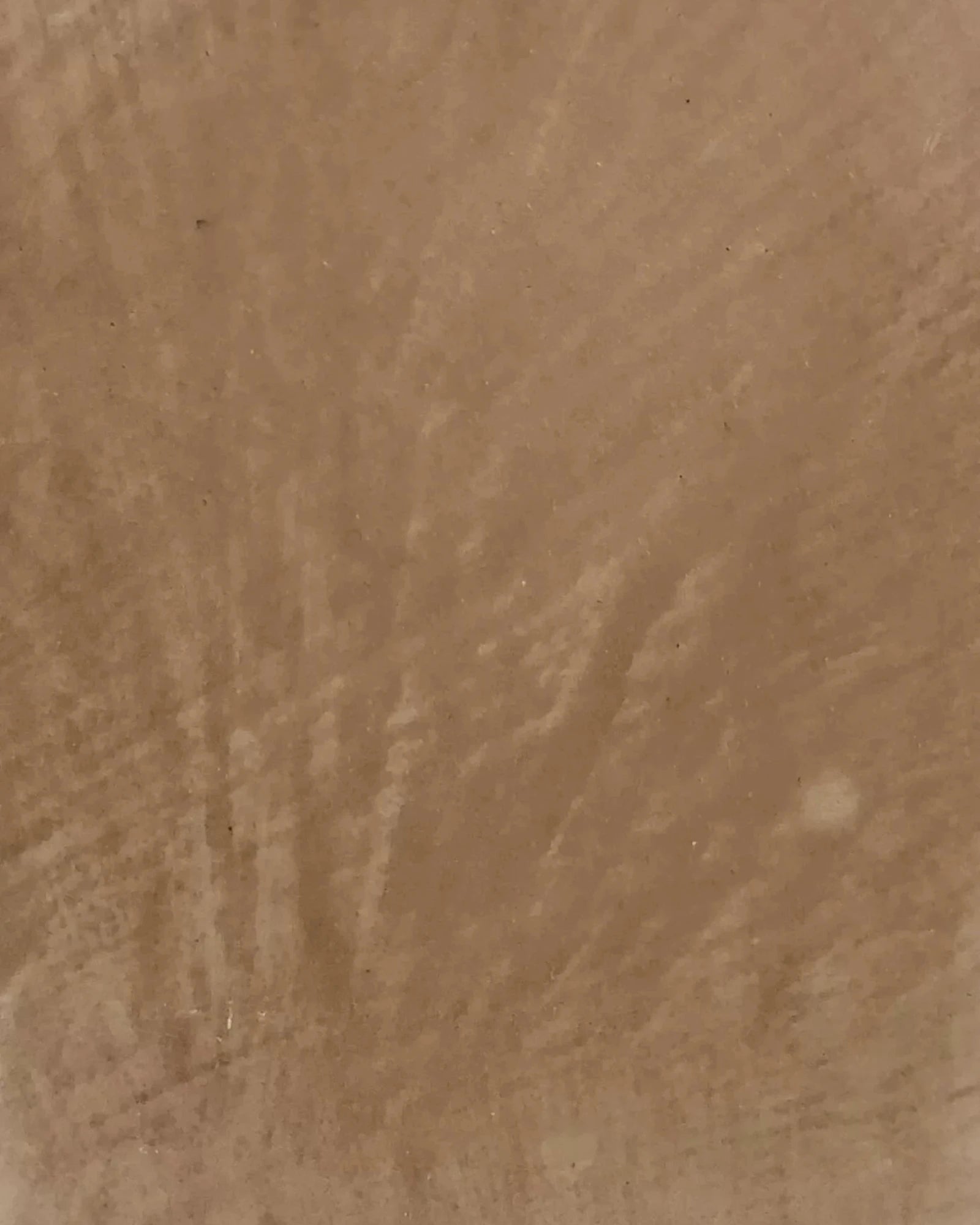 Close-up of textured brown marble surface with natural veining patterns