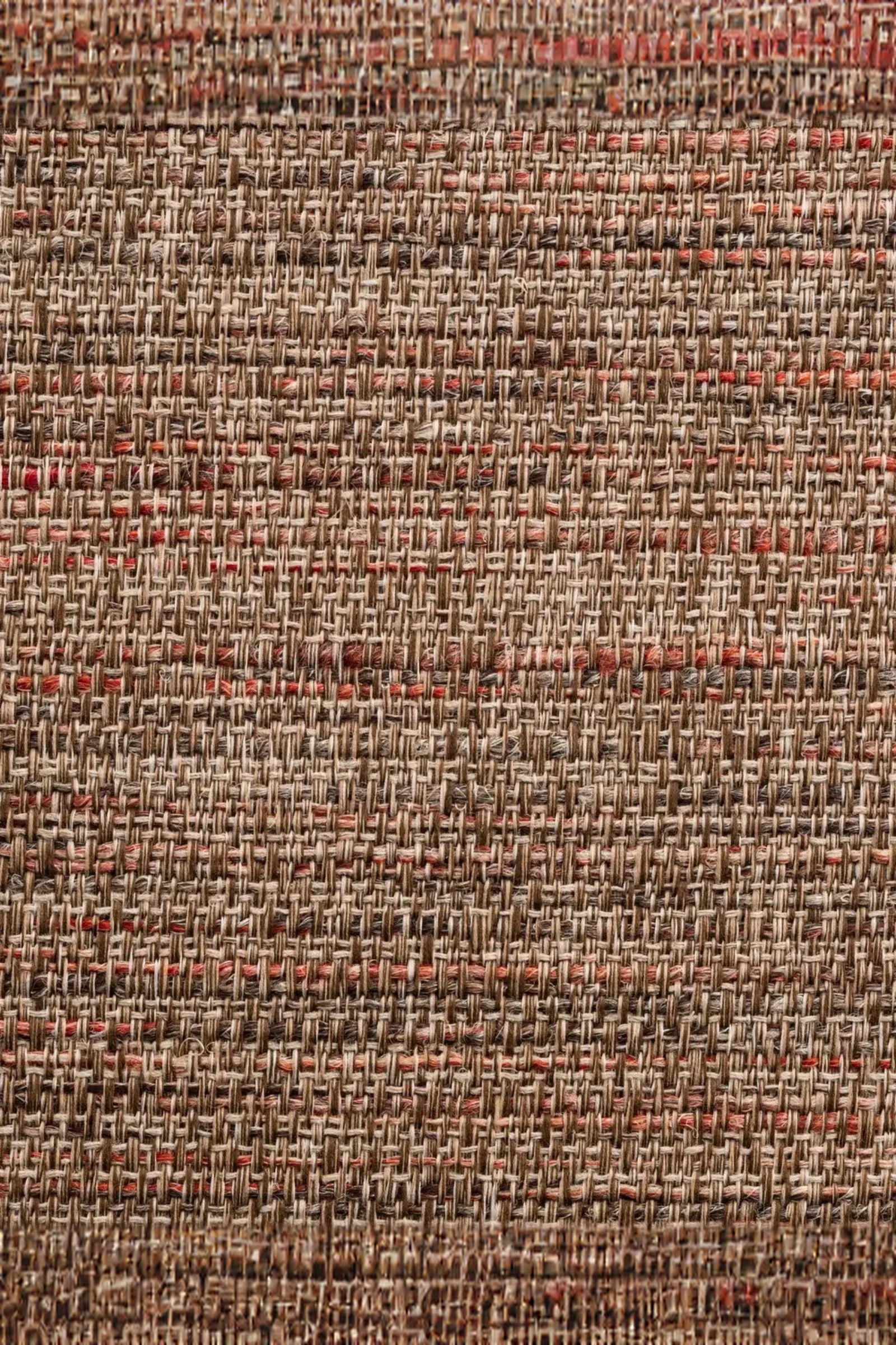 Close-up of woven natural fiber textile with beige and reddish-brown threads