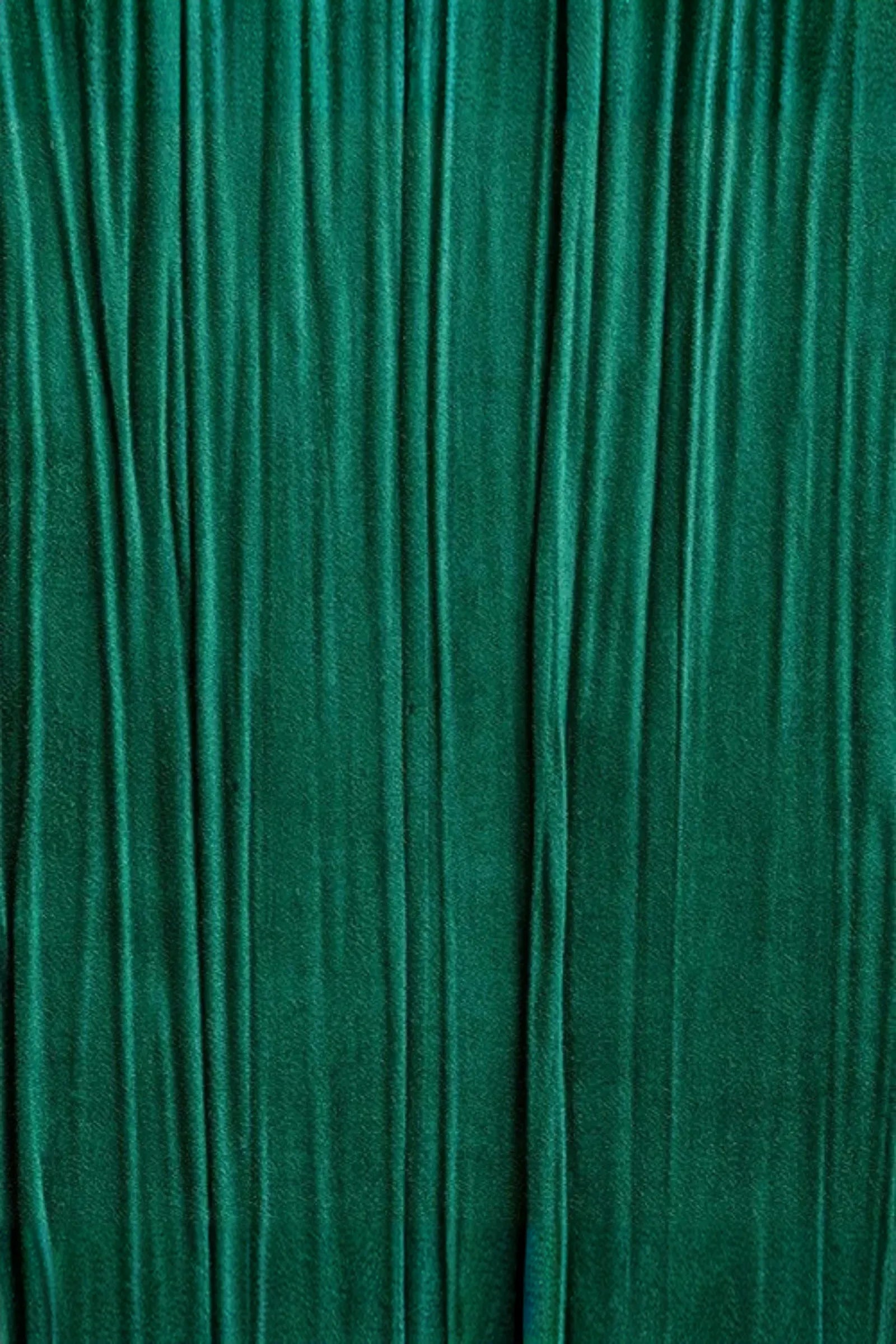 Rich green textured fabric with vertical pleats for luxury interior design