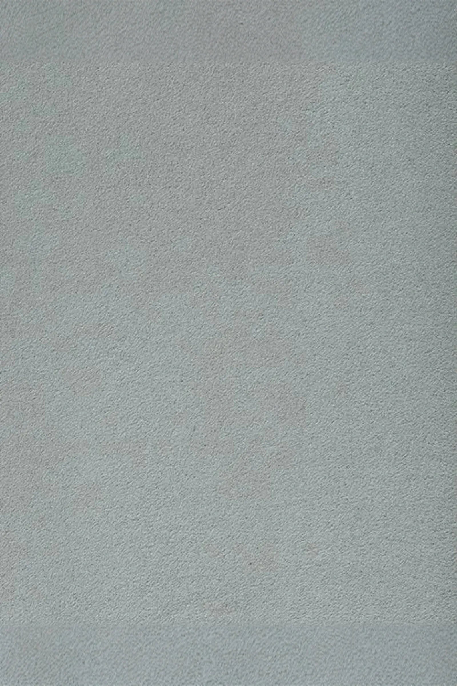 Light grey suede fabric texture, ideal for luxury interior upholstery