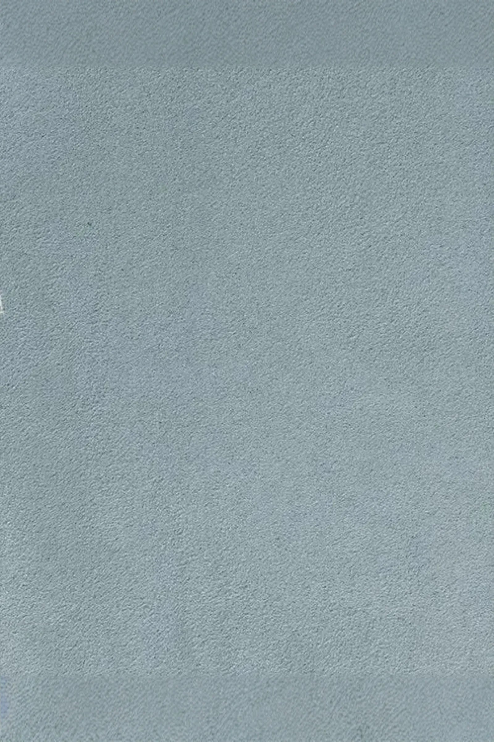 Light grey suede fabric texture, soft surface ideal for luxury interior design.