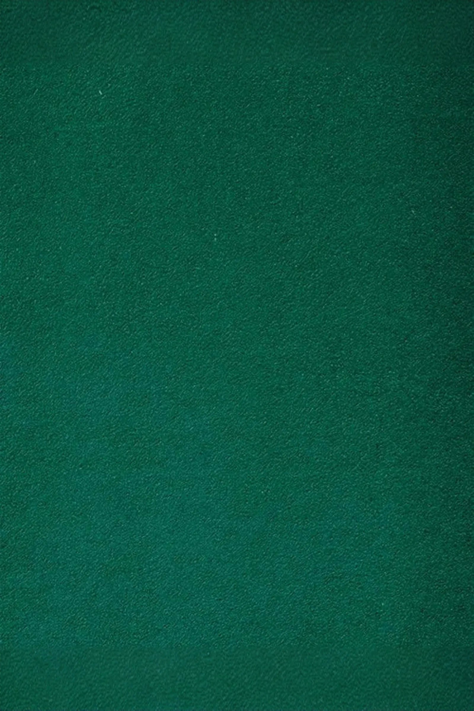 Emerald green suede upholstery fabric texture closeup
