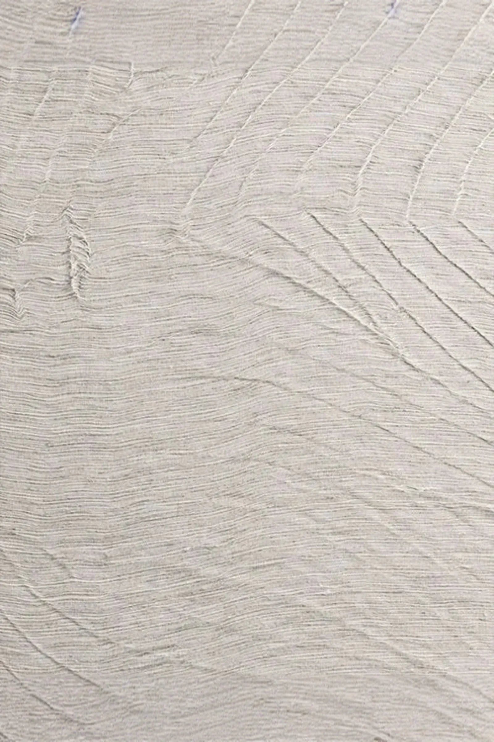 Alabaster sculpture surface with fine textured lines, luxury interior material detail