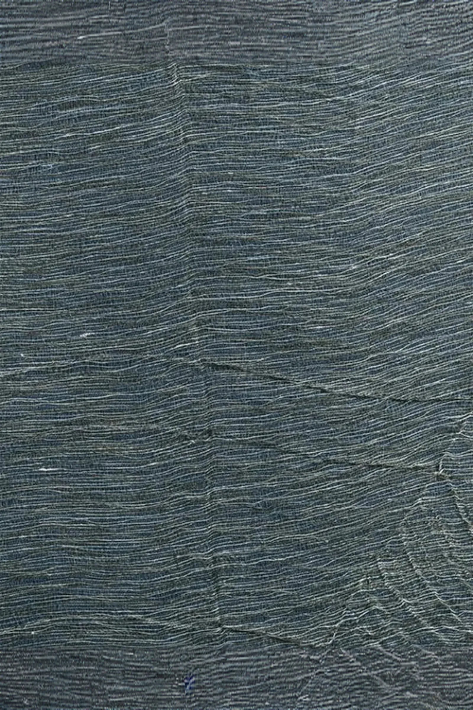 Close-up of textured woven fabric with undulating horizontal lines in dark gray tones