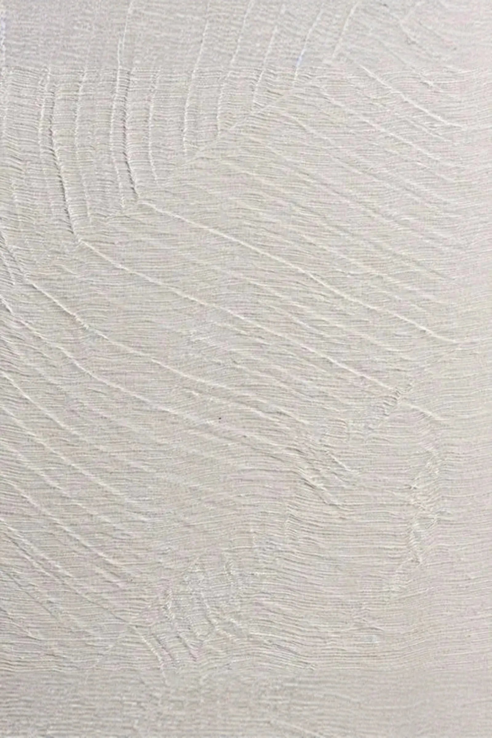 Textured white wall with subtle sculpted linear patterns for luxury interior design