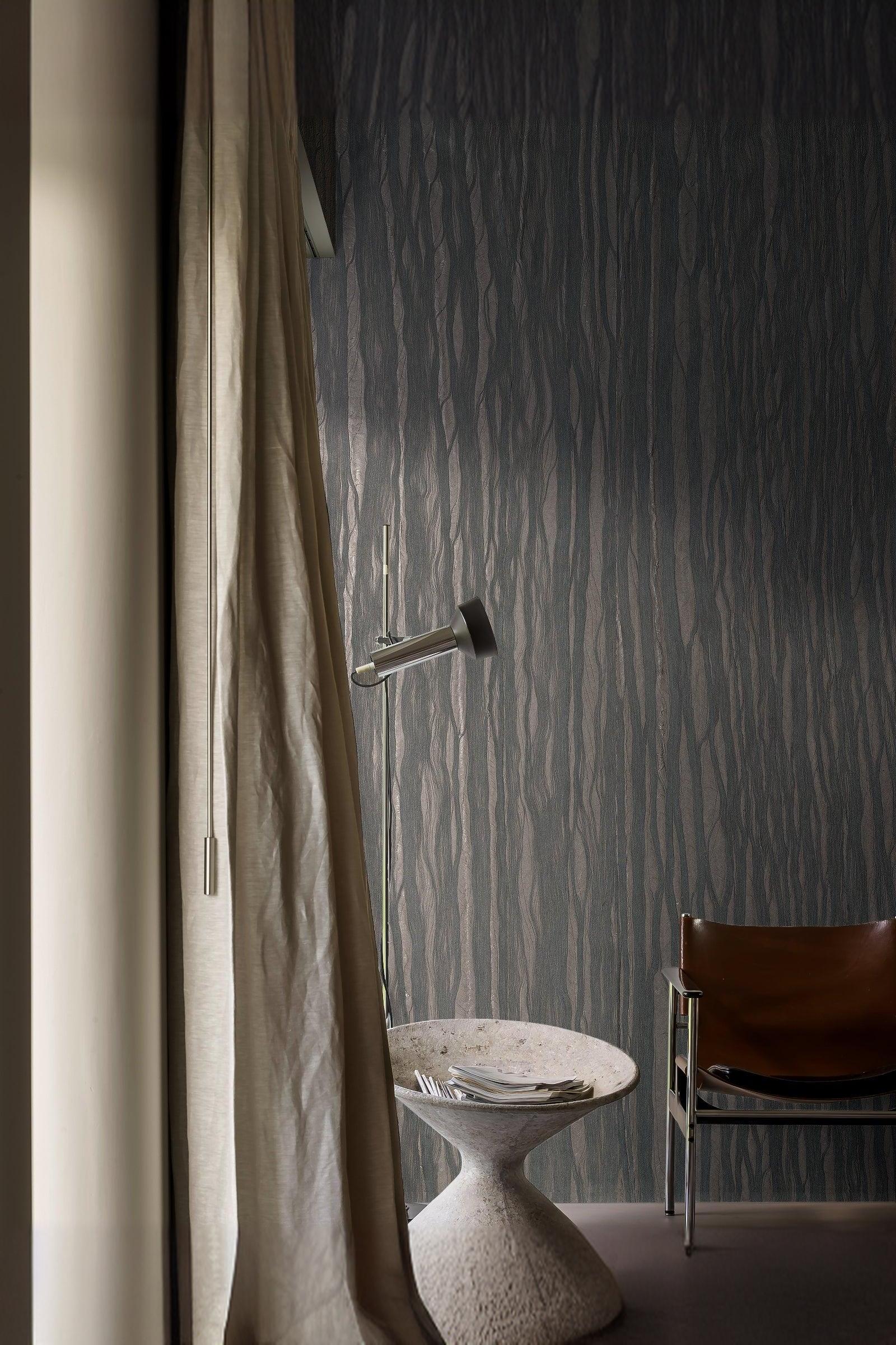 Modern luxury interior with textured dark wallpaper, marble side table, and leather chair