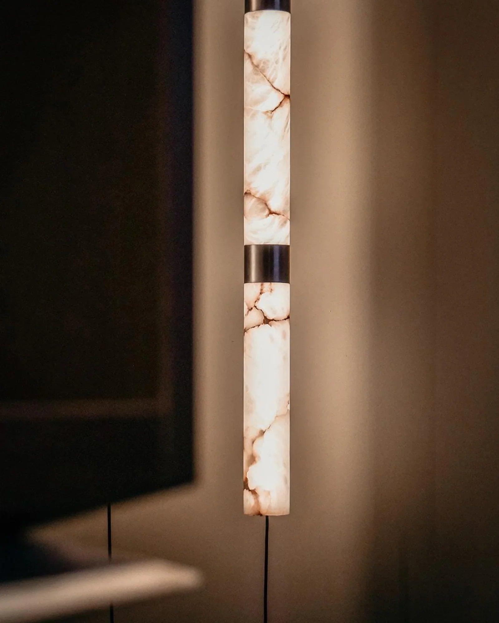 Modern marble pendant light with warm glow in a luxury interior setting