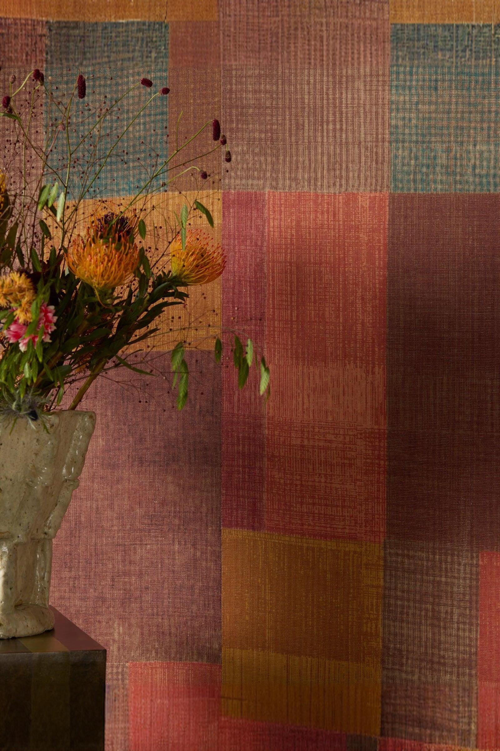 Modern luxury interior with colorful textured wall and ceramic vase of orange flowers