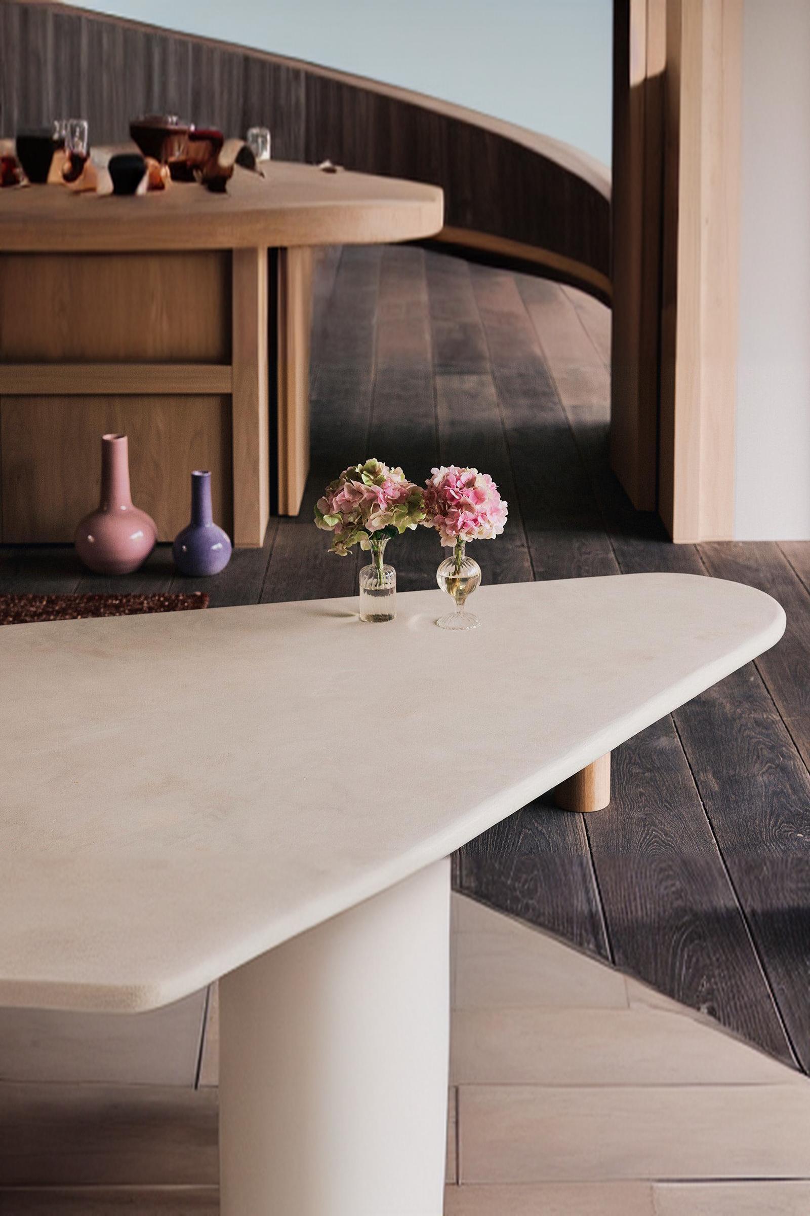 Modern luxury interior with round vases and pink hydrangeas on an elegant minimalist coffee table