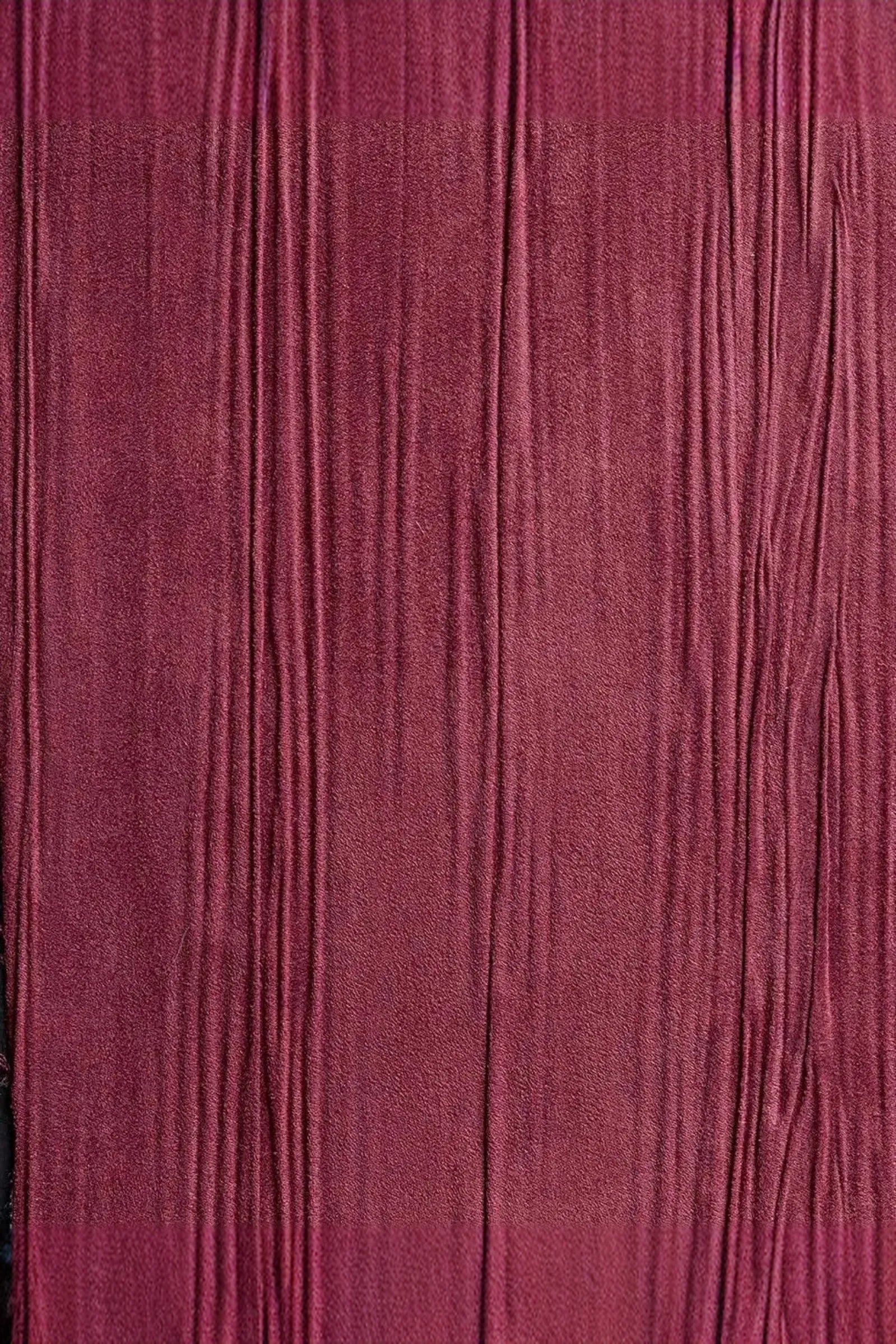 Textured burgundy wall panel with vertical lines for luxury interior design