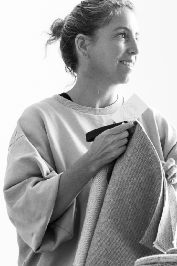 Woman working with textiles at Bruder &amp; Co atelier in Beernem, Belgium.